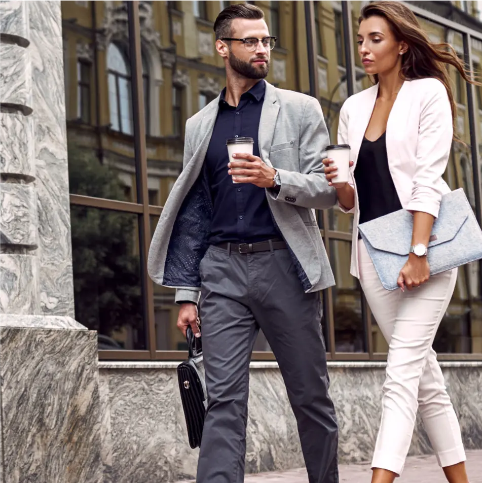 Product mock — two people walking a city street with coffee, captured as they go.