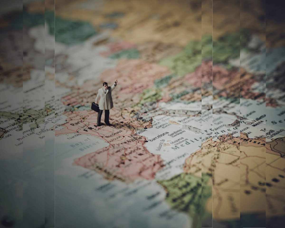 An image of the European map with a man and a suitcase standing on it, reflecting the importance of location data in tax audits.