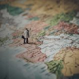 An image of the European map with a man and a suitcase standing on it, reflecting the importance of location data in tax audits.