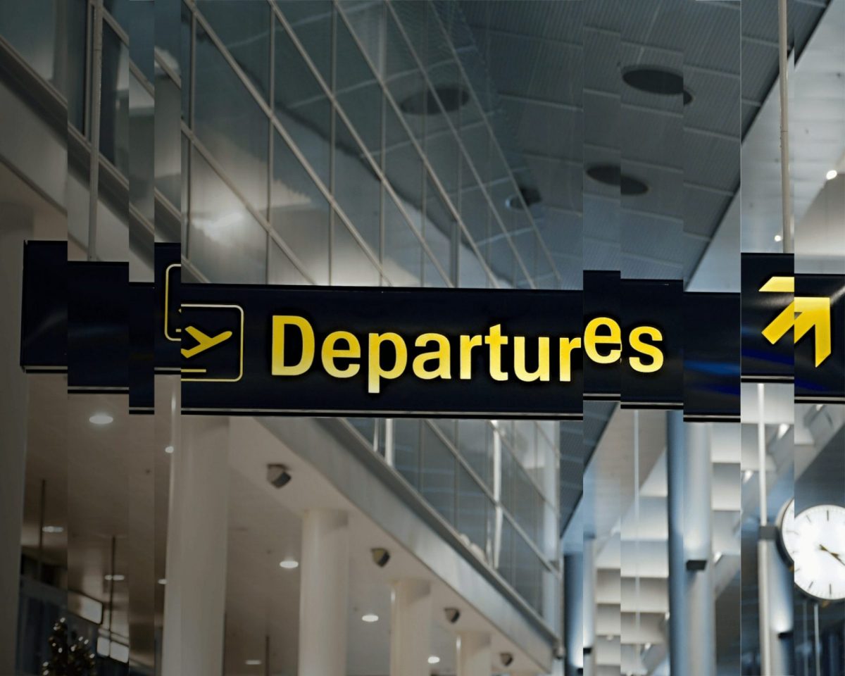 A distorted image of the departures sign at an airport to signify exit taxes, the topic of the article.